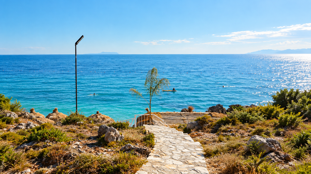 Scenic Albanian Riviera coastline with a stone path and turquoise sea.