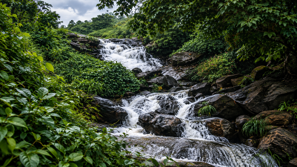  Hidden waterfall surrounded by dense green forest in Kerala
