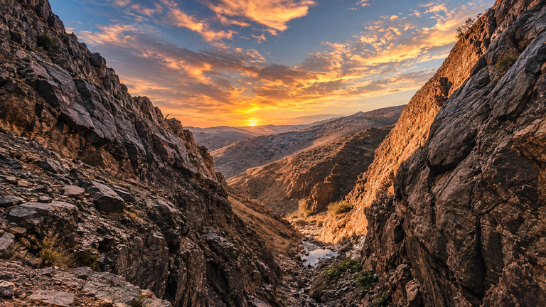 Jebel Shams canyon and mountains in Oman at sunset