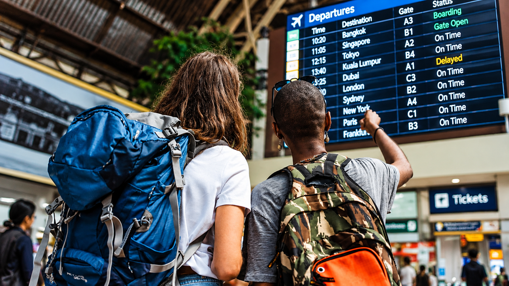 Solo traveler checking directions at a train station