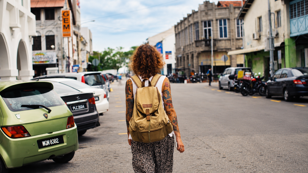 Solo traveler exploring a city with a backpack