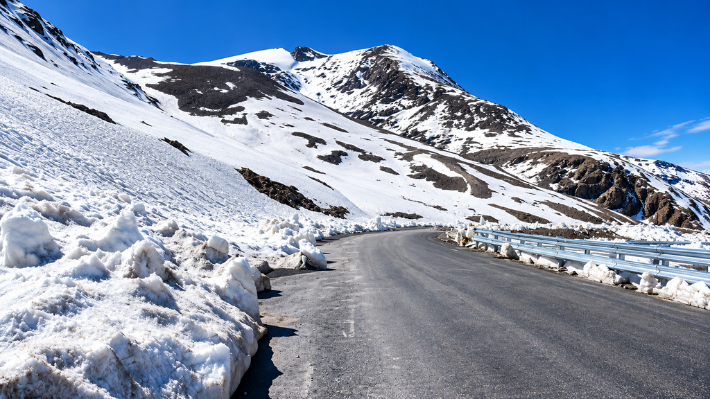 South Island New Zealand road beside mountains and a lake
