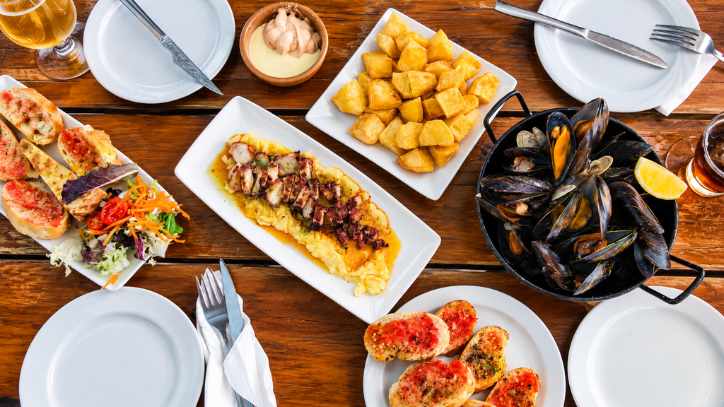 Spanish tapas and paella food table

