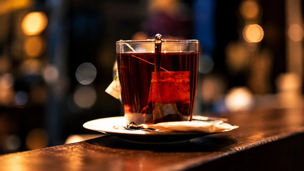 Warm cup of tea on a café table with soft lights