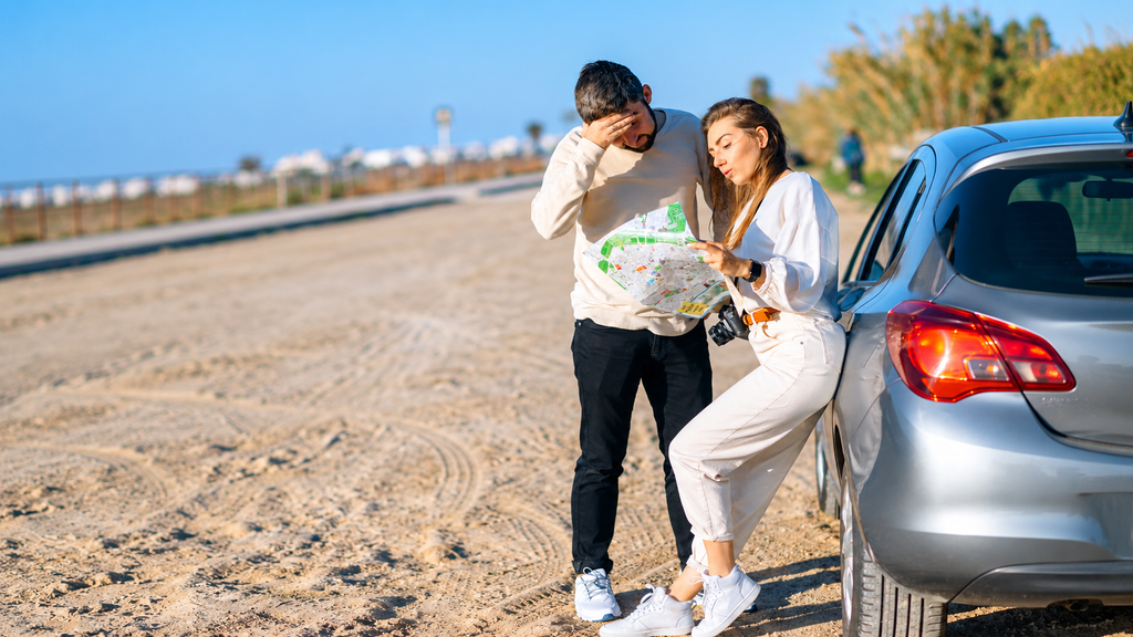 Traveler checking a map while exploring an unfamiliar road
