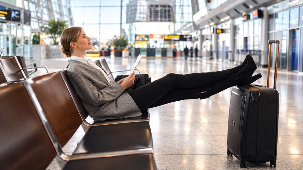 Traveler waiting at an airport with luggage