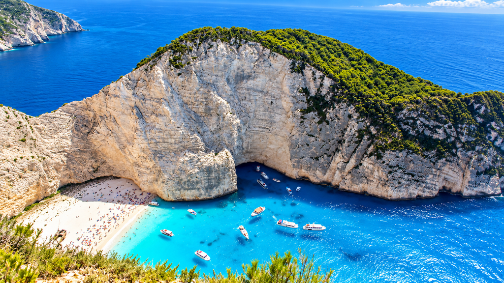 Navagio Beach in Zakynthos Greece surrounded by limestone cliffs
