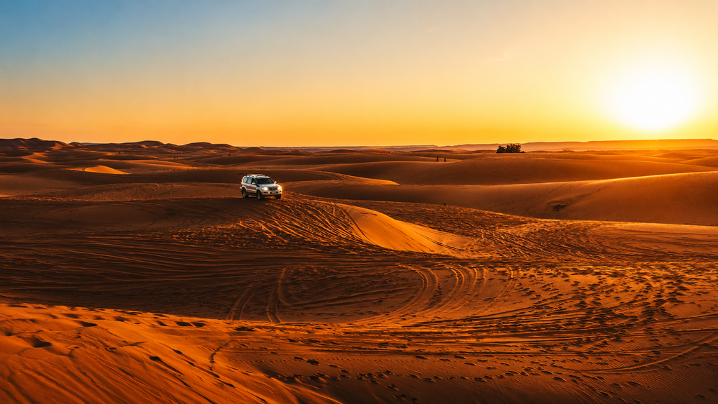 Golden sand dunes at sunset in Wahiba Sands Oman