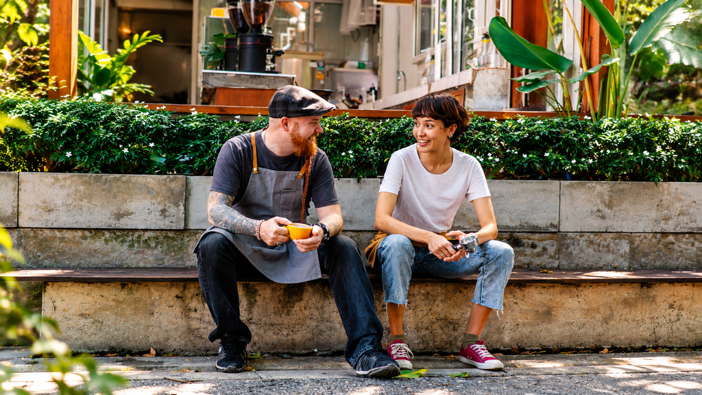 Traveler talking with a local at a small roadside café