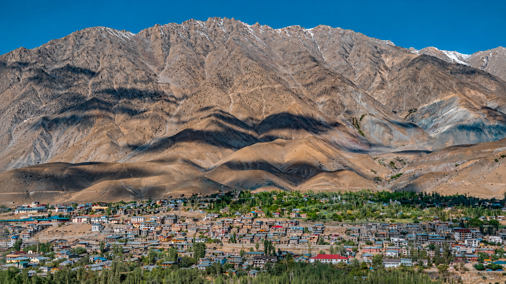 Leh town surrounded by dry brown mountains and blue skies in Ladakh. Best Places to Visit in Ladakh


