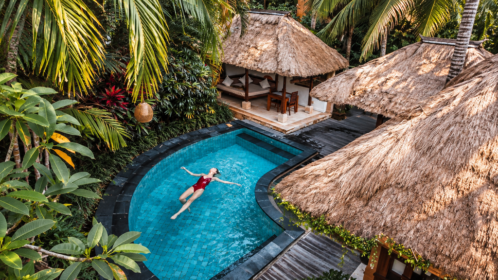  Private pool villa in Ubud, Bali, surrounded by palm trees and green rice fields. 7 days in Bali
