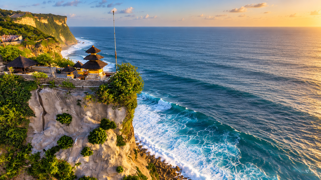  Uluwatu Temple on a cliff above the ocean in Bali at sunset with an orange sky.
