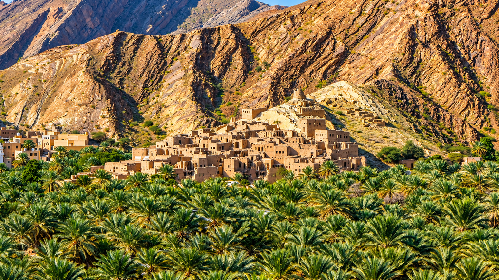 Wadi Tiwi valley with palm trees and mountains Oman